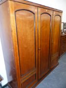 A VICTORIAN HOWARD & SONS COMPACTUM WARDROBE WITH THREE PANEL DOORS ENCLOSING SLIDES, DRAWER AND