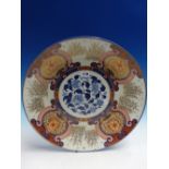 A JAPANESE FUKUGAWA IMARI DISH, THE RUYI FRAMED FLORAL LAPPETS ALTERNATING WITH STANDS OF BAMBOO AND