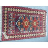 A BELOUCH TRIBAL RUG. 155 x 91cms TOGETHER WITH AN ORIENTAL RUG OF BOKHARA DESIGN. 175 x 125cms. (
