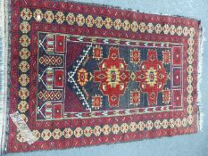 A BELOUCH TRIBAL RUG. 155 x 91cms TOGETHER WITH AN ORIENTAL RUG OF BOKHARA DESIGN. 175 x 125cms. (