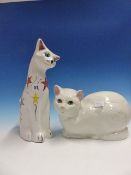 A BRANNAM WHITE SEATED CAT COLOURED WITH STARS, H.34cms TOGETHER WITH A WHITE POTTERY CAT