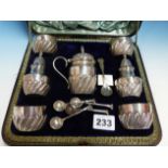 A SILVER HALLMARKED CASED CONDIMENT SET TO INCLUDE TWO PEPPERS, FOUR SALTS AND A MUSTARD POT.