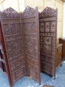 AN ANGLO INDIAN FOUR FOLD WOODEN SCREEN, THE PIERCED AND CARVED PANELS OF GRAPES WITHIN FRAMES