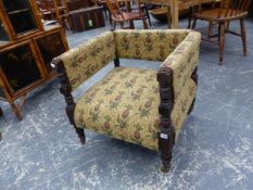 A LATE VICTORIAN SQUARE BACK LOW ARMCHAIR ON TURNED LEGS WITH BRASS CASTERS.