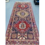 A PERSIAN TRIBAL RUG. 328 x 140cms