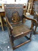 AN ANTIQUE.COUNTRY OAK WAINSCOT CHAIR WITH CARVED PANEL BACK.