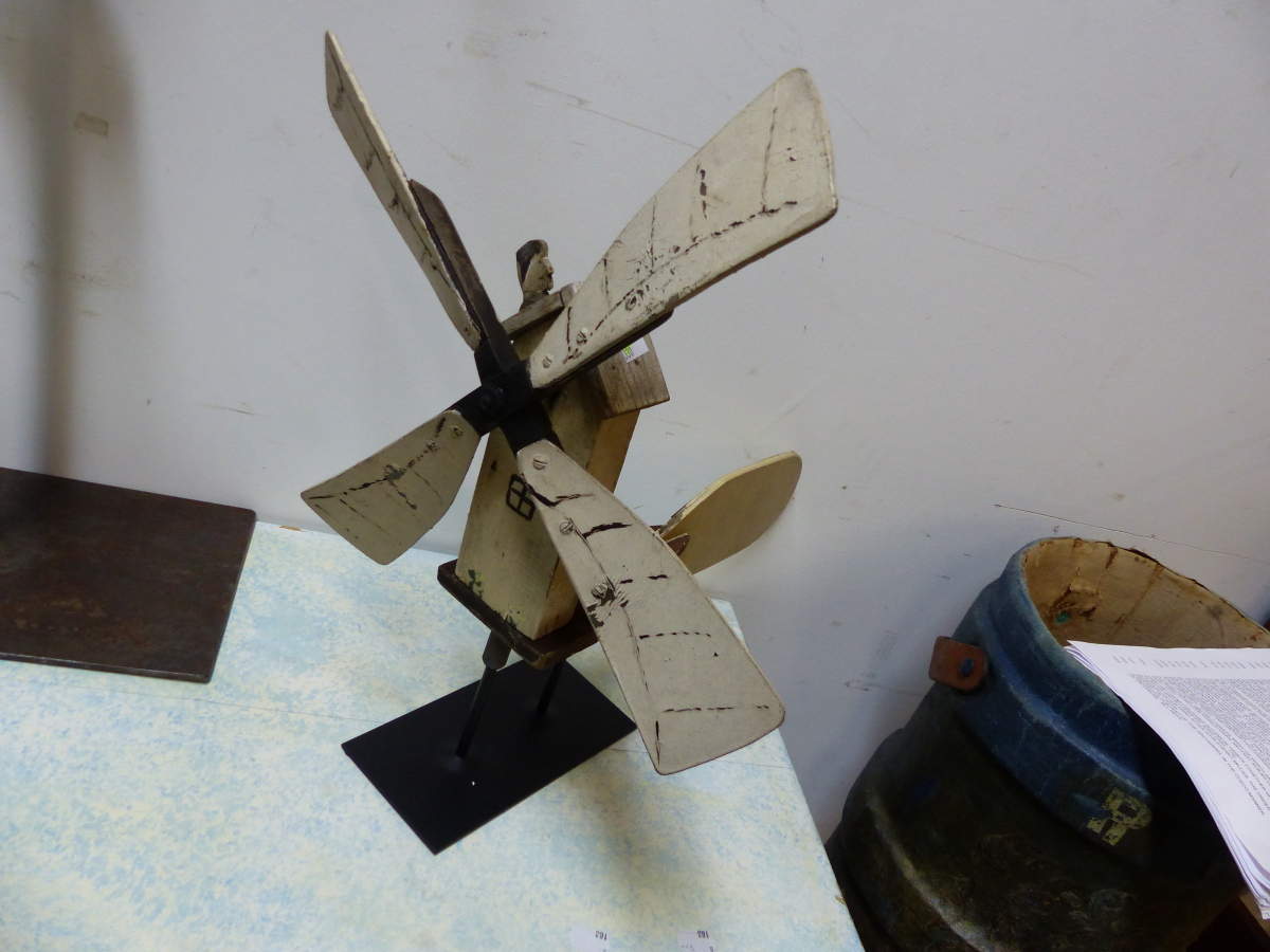 A PAINTED WOOD WEATHER VANE IN THE FORM OF A WINDMILL THE SAILS MOVING A SEGMENTAL FIGURE OF A MAN
