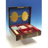 A VICTORIAN CORAMANDEL AND GILT BRASS MOUNTED GAMES COMPENDIUM FITTED FOR VARIOUS CARD, DICE AND