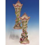 A PAIR OF FLORAL ENCRUSTED VASES WITH PINK RIMS. H.27.5cms.