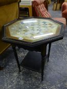 AN EBONISED AND PARCEL GILT TWO TIER GAMES TABLE, THE TOP GLAZED OVER A CHESS BOARD WITH PAINTED