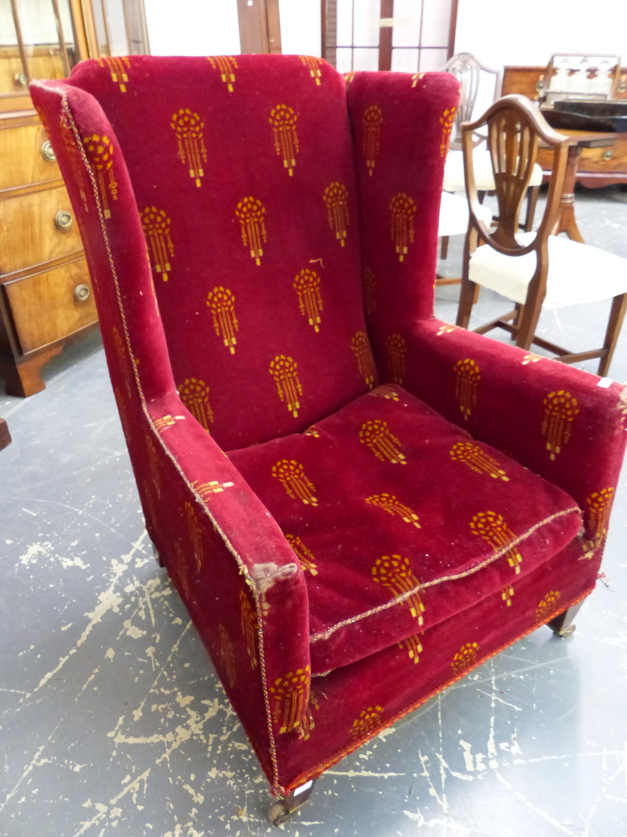 AN EDWARDIAN WING BACK ARMCHAIR WITH PERIOD VELOUR UPHOLSTERY ON SHORT SQUARE TAPERED LEGS AND