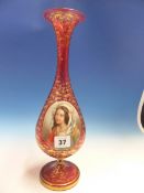 A BOHEMIAN GILT CRANBERRY GLASS BALUSTER VASE PAINTED WITH A RAISED OVAL OF A LADY. H 36cms.