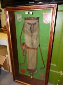 A VINTAGE GOLFING DISPLAY OF EARLY 20th.C.BAG & CLUBS, CRESTED CLUB SHIELD AND A TROPHY IN A