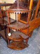 A BURR WALNUT WHATNOT OF FOUR QUARTER ROUND SHELVES SUPPORTED ON BARLEY TWIST COLUMNS. W 66 x D 44 x