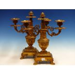 A PAIR OF ORMOLU TWO BRANCH CANDLEABRA, THE ARMS SCROLLING EITHER SIDES OF CENTRAL VASES ON SQUARE