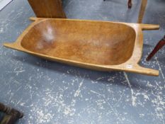 AN ANTIQUE CONTINENTAL TREEN DUG-OUT DOUGH BIN. L.139cms.