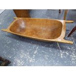 AN ANTIQUE CONTINENTAL TREEN DUG-OUT DOUGH BIN. L.139cms.