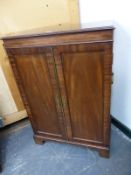 AN ANTIQUE GEORGIAN STYLE MAHOGANY SIDE CABINET, THE RECTANGULAR TOP OVER PANEL DOORS ENCLOSING