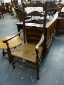 AN ANTIQUE LADDER BACKED ELBOW CHAIR WITH RUSH SEAT ABOVE BALUSTER FRONT LEGS ON PAD FEET.