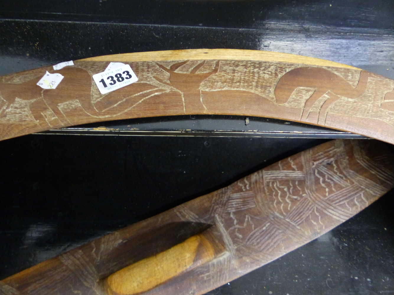 AN ABORIGINAL WOODEN SHIELD AND A BOOMERANG RELIEF CARVED WITH A KANGEROO AND A MOA. - Image 2 of 3