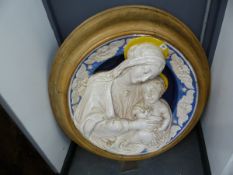 A FRAMED DELLA ROBBIA TYPE POTTERY PLAQUE OF THE MADONNA AND CHILD THEIR YELLOW HALOES CONTRASTING