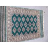 AN ORIENTAL RUG OF BOKHARA DESIGN. 178 x 125cms. TOGETHER WITH AN UNUSUAL TRIBAL RUG. 146 x 108cms.
