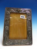 A CHESTER SILVER MOUNTED ART NOUVEAU OAK PHOTOGRAPH FRAME.