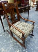 AN EDWARDIAN MAHOGANY ROCKING CHAIR, INLAID WITH A FOLIATE CARTOUCHE TO THE TOP RAIL CENTRALLY ABOVE