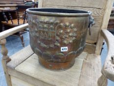 A BRASS COAL BUCKET WITH LION MASK AND RING HANDLES, THE ARMORIAL ENGRAVED SIDES ROUNDING DOWN TO