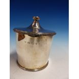 A SILVER ICE BUCKET WITH GILT STRAINER BY FH, LONDON 2006, THE COVER AND FOOT RIM BEADED. H 17cms.