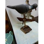 A PAINTED WOOD DECOY PIGEON MOUNTED ON A ROD ON A SECTION OF BIRCH BRANCH, THE BIRD. W 33cms.