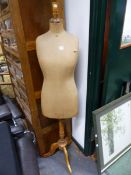 A LEVINE FEMALE MANNEQUIN WITH A PEG HEAD ABOVE A WAIST LENGTH BODY SUPPORTED ON COLUMN AND