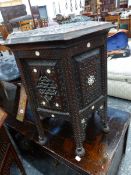 AN ISLAMIC HEXAGONAL TABLE INTAGLIO CARVED WITH ARABESQUES AND INLAID WITH MOTHER OF PEARL FLOWER