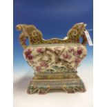 A ZSOLNAY PECS LARGE POTTERY JARDINIERE WITH AESTHETIC FLORAL DECORATION AND LION FORM HANDLES.