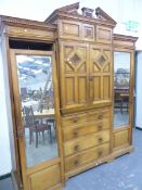 A VICTORIAN ASH BREAKFRONT COMPACTUM, THE MIRRORED CUPBOARD DOORS FLANKING TWO PAIRS OF DOORS