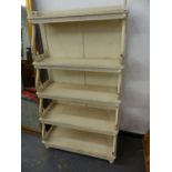 AN ANTIQUE STYLE PAINTED WATERFALL BOOKCASE WITH SHAPED SHELF SUPPORTS. 89 x 42 x H.160cms.