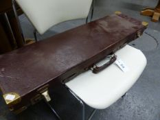 A VINTAGE GUN CASE WITH BRASS CORNERS AND VARIOUS GUNSLIPS.