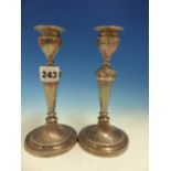 A PAIR OF HALLMARKED SILVER CANDLESTICKS WITH TWIST DECORATION AND WEIGHTED BASES.