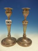 A PAIR OF HALLMARKED SILVER CANDLESTICKS WITH TWIST DECORATION AND WEIGHTED BASES.