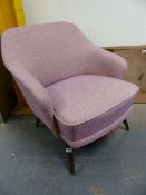 A RETRO PINK PATTERNED UPHOLSTERED ARMCHAIR.