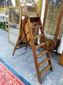 A TEAK LIBRARY STEP LADDER WITH HANDLES ABOVE THE SEVEN TREADS. H 169cms.