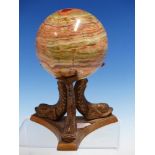 AN AGATE BALL ON BRONZE STAND OF THREE DOLPHINS, THE BALL Dia.10cms.