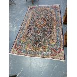 A PERSIAN KIRMAN RUG. 245 x 146cms.