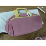 A RADLEY PINK TEXTILE HANDBAG WITH LIME LEATHER HANDLES AND EDGINGS, THE INTERIOR LINED WITH