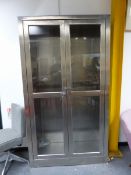 A LARGE BRUSHED STEEL DISPLAY CABINET.