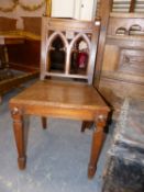 A PAIR OF VICTORIAN GOTHIC REVIVAL OAK HALL CHAIRS ON SHAPED FORELEGS. (2)