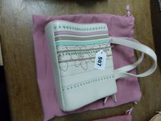 A RADLEY CREAM LEATHER HANDBAG SEWN WITH FLOWER HEADS AND TURQUOISE, PINK AND BROWN LEATHER BANDS