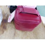 A RADLEY FOLD AWAY PINK BAG MADE FROM WASTE PLASTIC BOTTLES, A RED LEATHER ZIP UP MAKE UP BAG