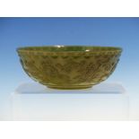 A CHINESE SPINACH GREEN HARDSTONE BOWL, THE EXTERIOR WITH RUYI LAPPET RIM BAND ABOVE TWO LOTUS