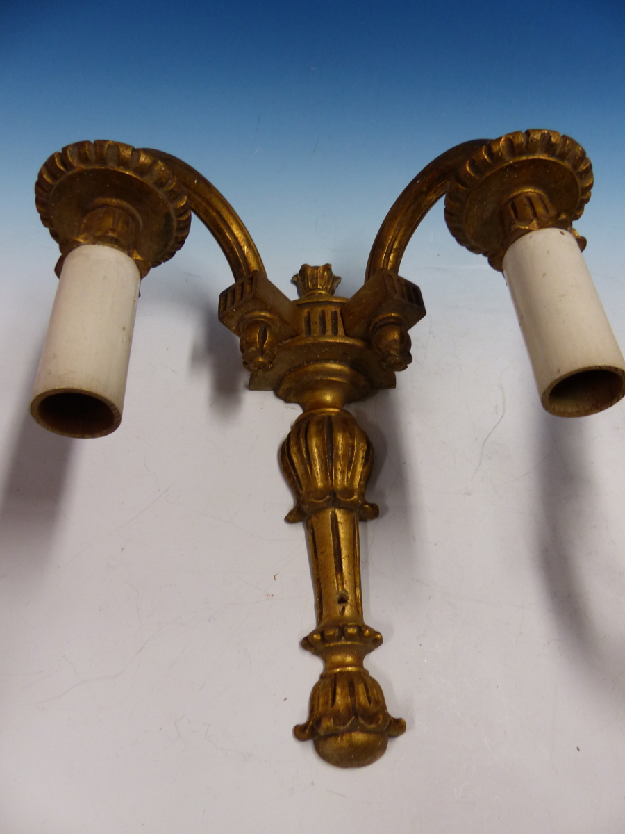 A PAIR OF GILT WOOD TWO BRANCH WALL LIGHTS, THE FLUTED NOZZLES AND ARMS SCROLLING TO THE BASES OF - Image 2 of 2